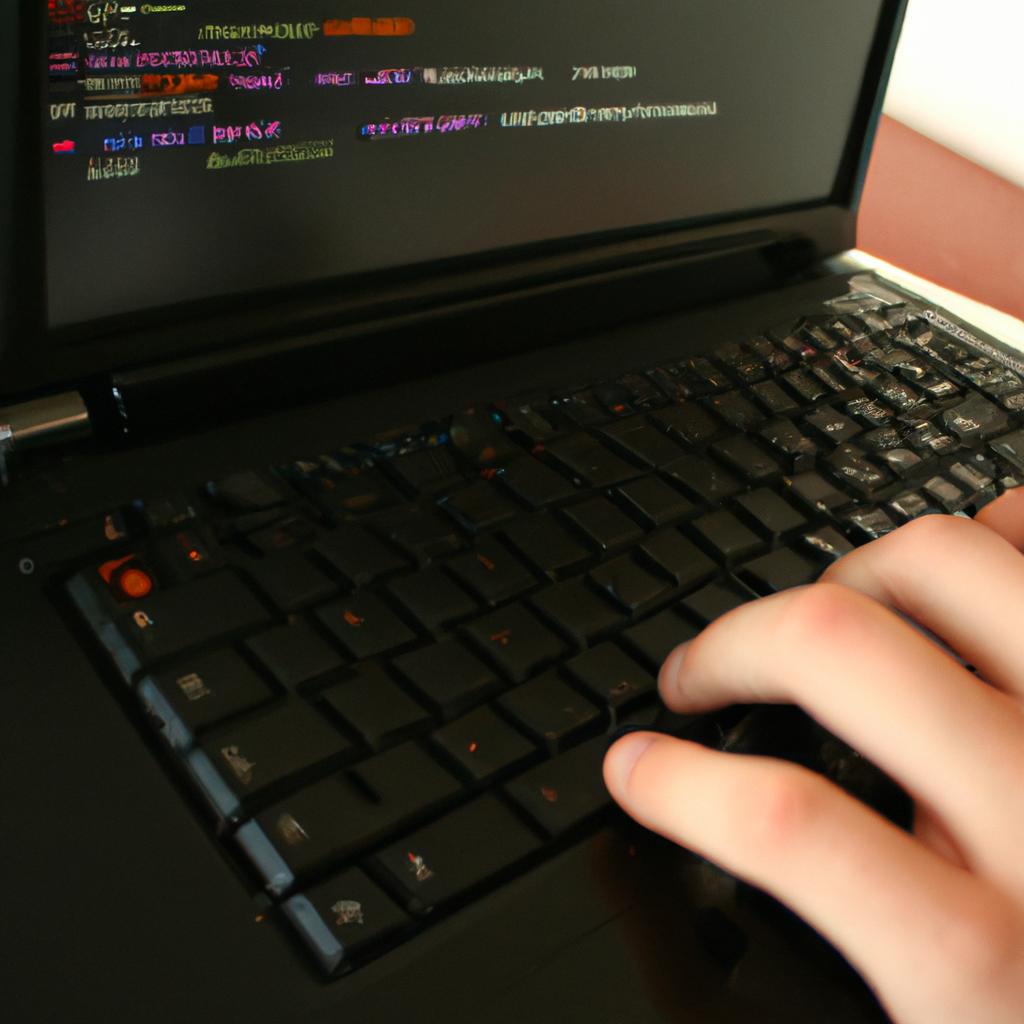 Person coding on a laptop