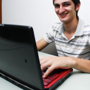 Person working on laptop, smiling